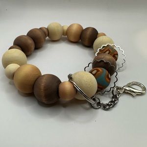 10.5" wristlet/keychain. Handmade using wooden and handmade polymer clay beads